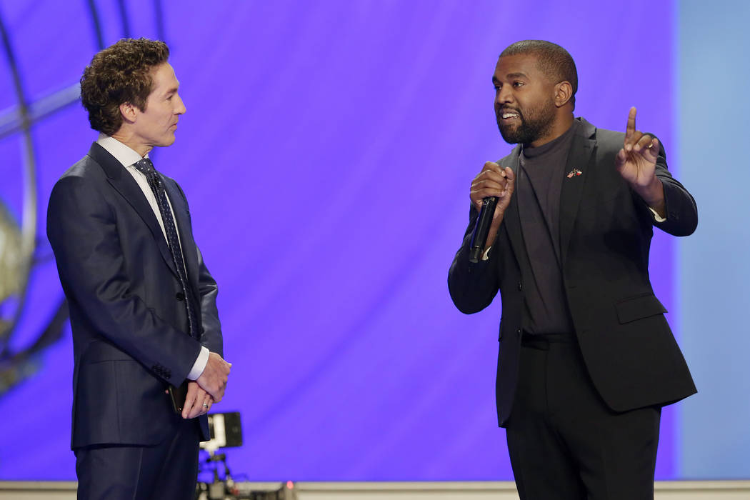 Rapper Kanye West, right, answers questions from Joel Osteen, left, during a service at Lakewoo ...