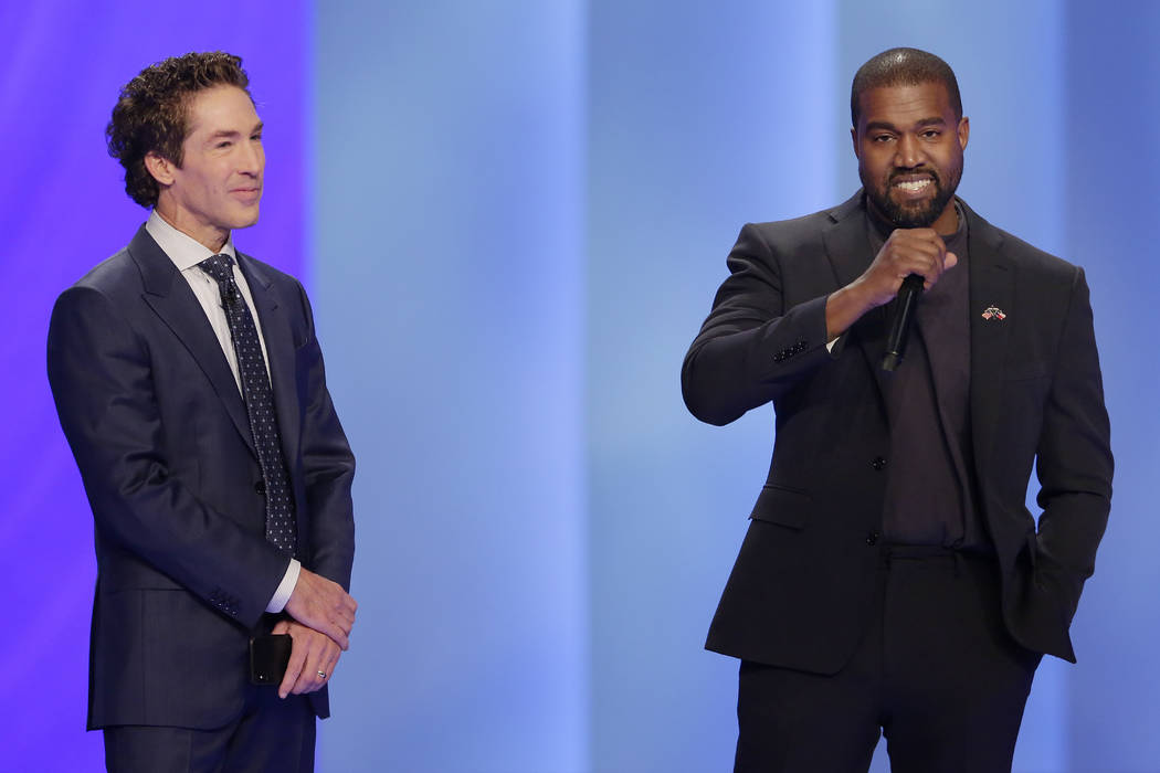 Rapper Kanye West, right, answers questions from Joel Osteen, left, during a service at Lakewoo ...