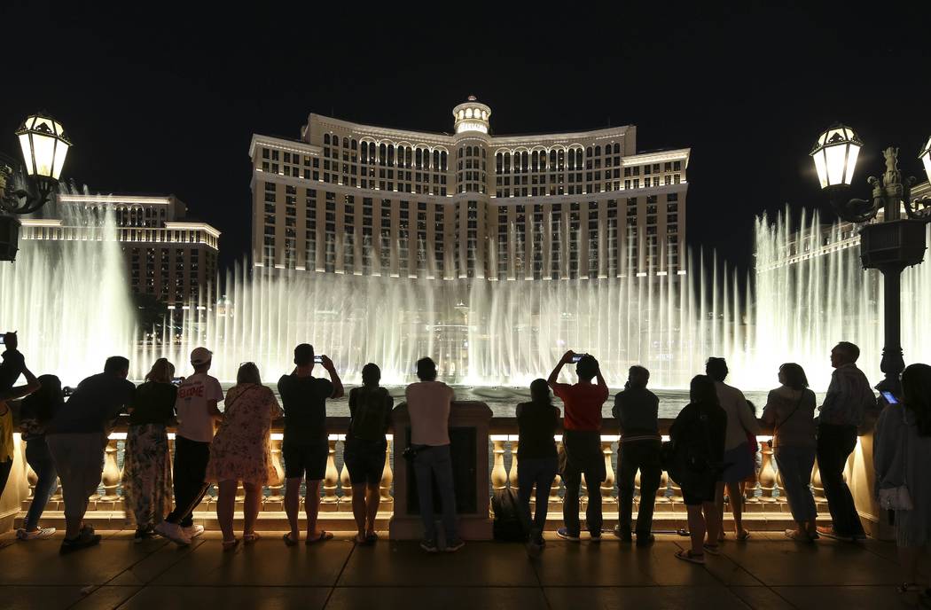 People watch the water fountain show outside the Bellagio on the Las Vegas Strip. (Richard Bria ...