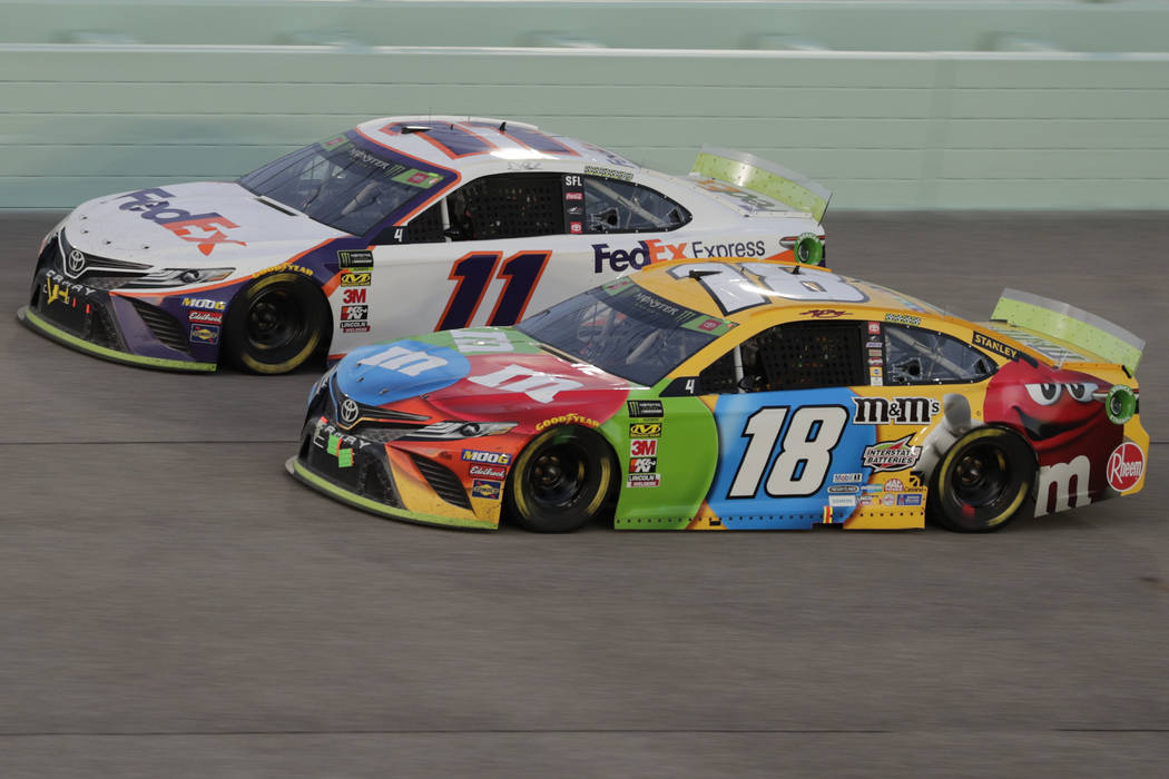Kyle Busch (18) and Denny Hamlin (11) are seen during the NASCAR Cup Series auto racing season ...