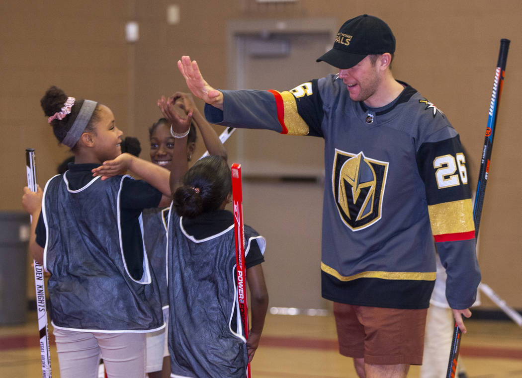 Vegas Golden Knights forward Paul Stastny celebrates a goal by his team as he and teammate Max ...