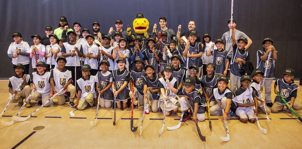 Vegas Golden Knights forwards Max Pacioretty and Paul Stastny with Chance the Gila monster pose ...