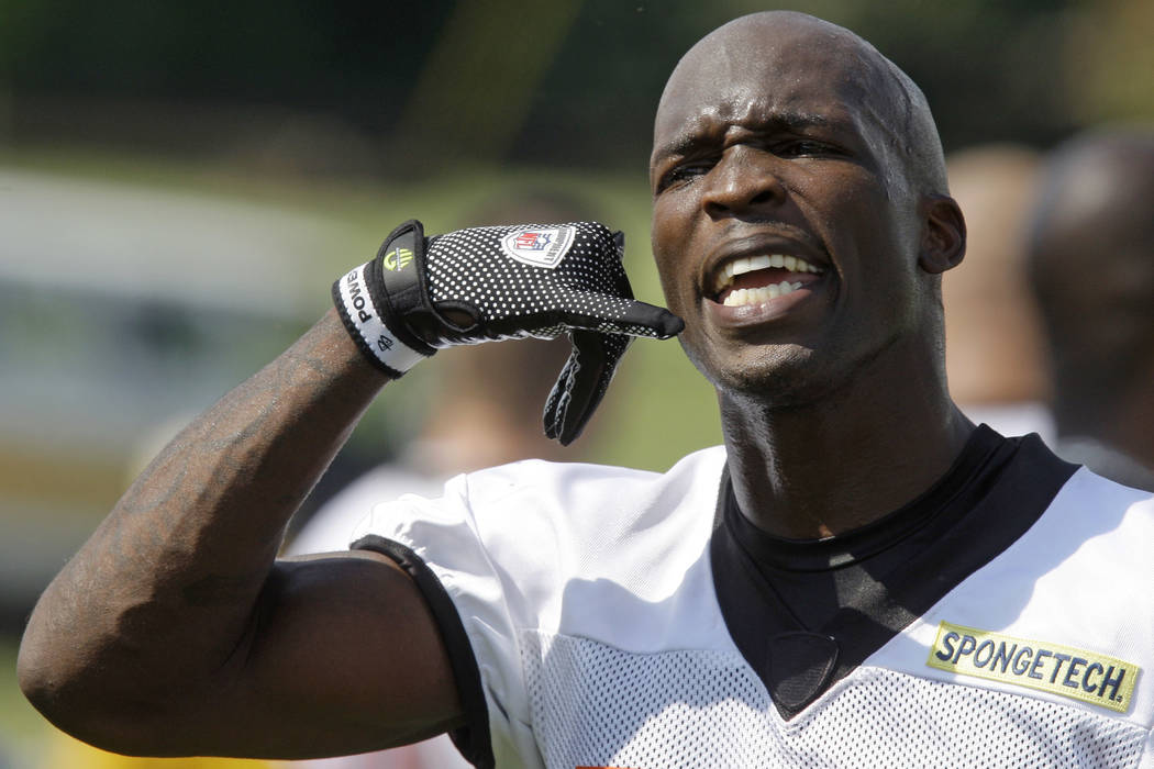 Former Cincinnati Bengals receiver Chad Ochocinco acknowledges a fan during their first practic ...