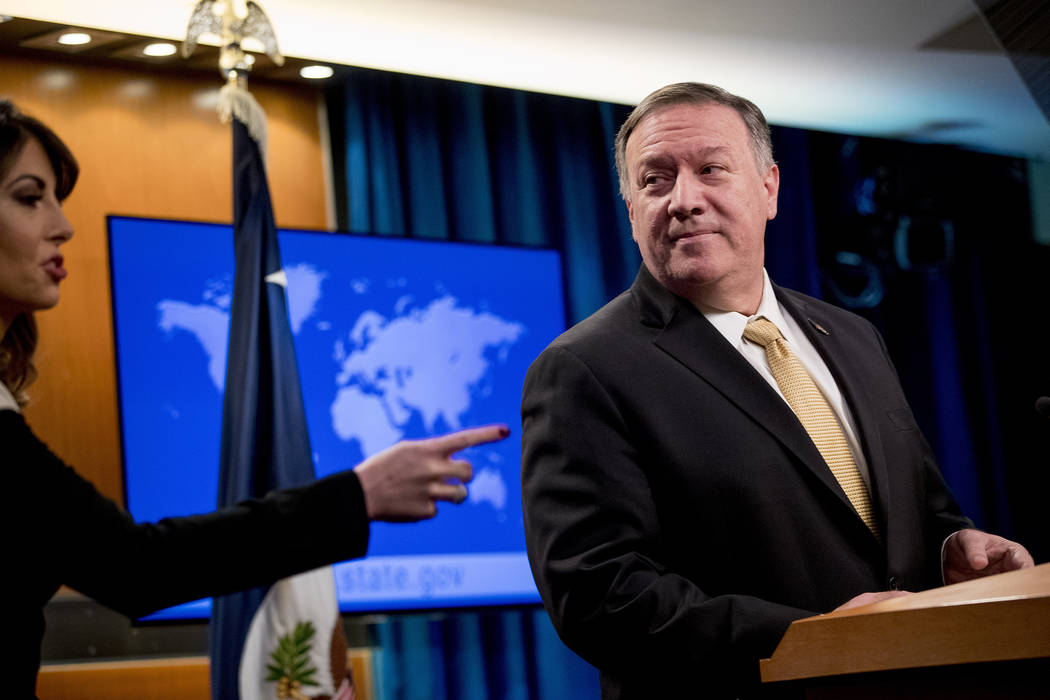 Secretary of State Mike Pompeo, right, pauses as State Department spokeswoman Morgan Ortagus, l ...