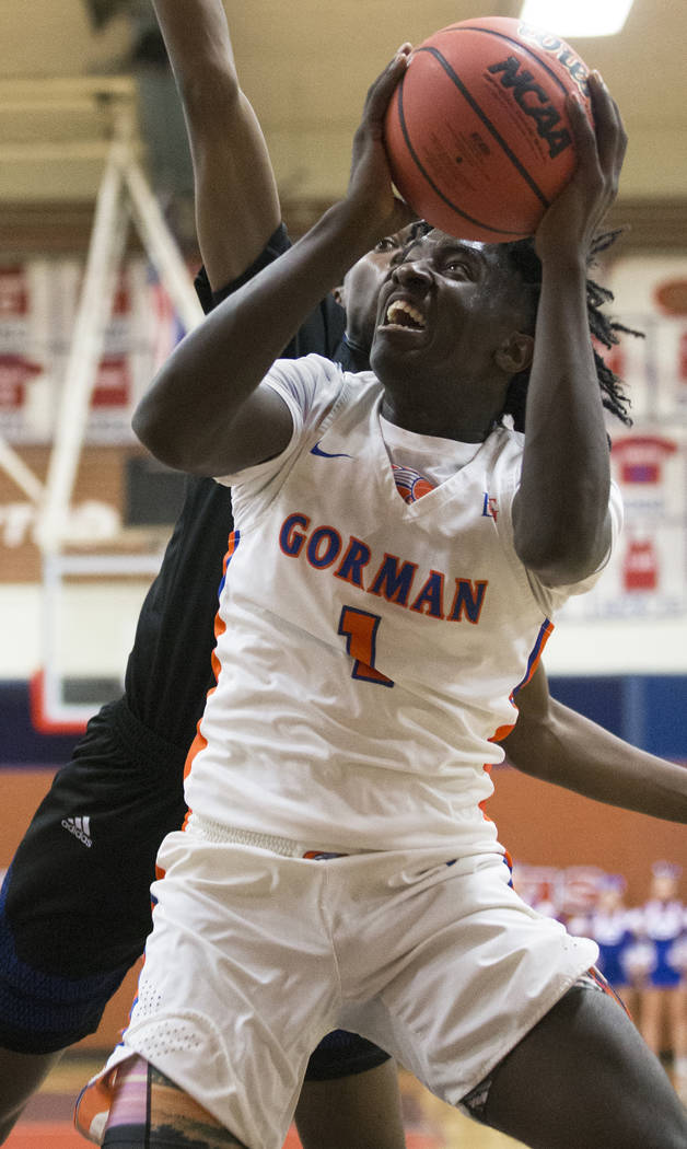 Bishop Gorman sophomore guard Will McClendon (1) drives baseline past Desert Pines sophomore Da ...