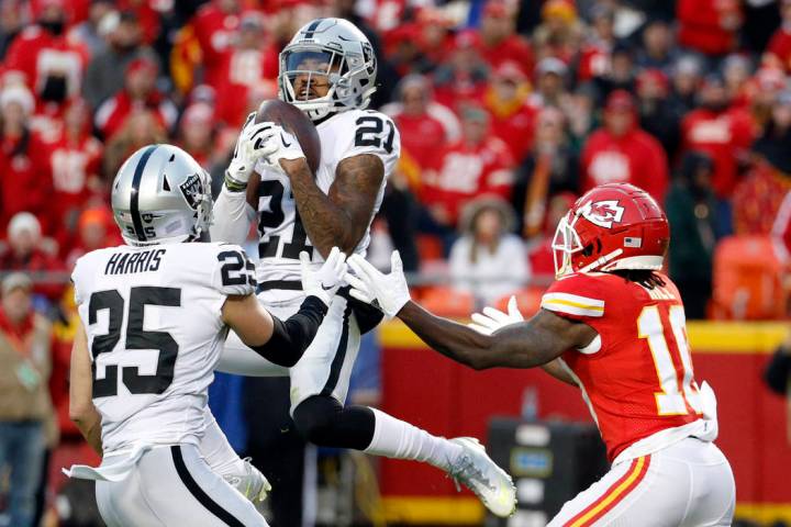 Oakland Raiders safety Erik Harris (25) watches as cornerback Gareon Conley (21) intercepts a p ...