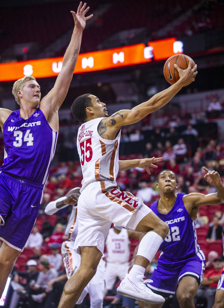 UNLV Rebels guard Elijah Mitrou-Long (55, right) gets inside of Abilene Christian Wildcats cent ...