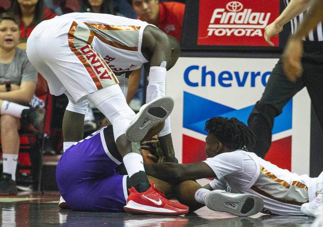 UNLV Rebels forward Mbacke Diong (34, above) reaches for a loose ball with Abilene Christian Wi ...