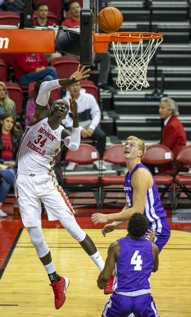 UNLV Rebels forward Mbacke Diong (34, left) touches in a basket past Abilene Christian Wildcats ...
