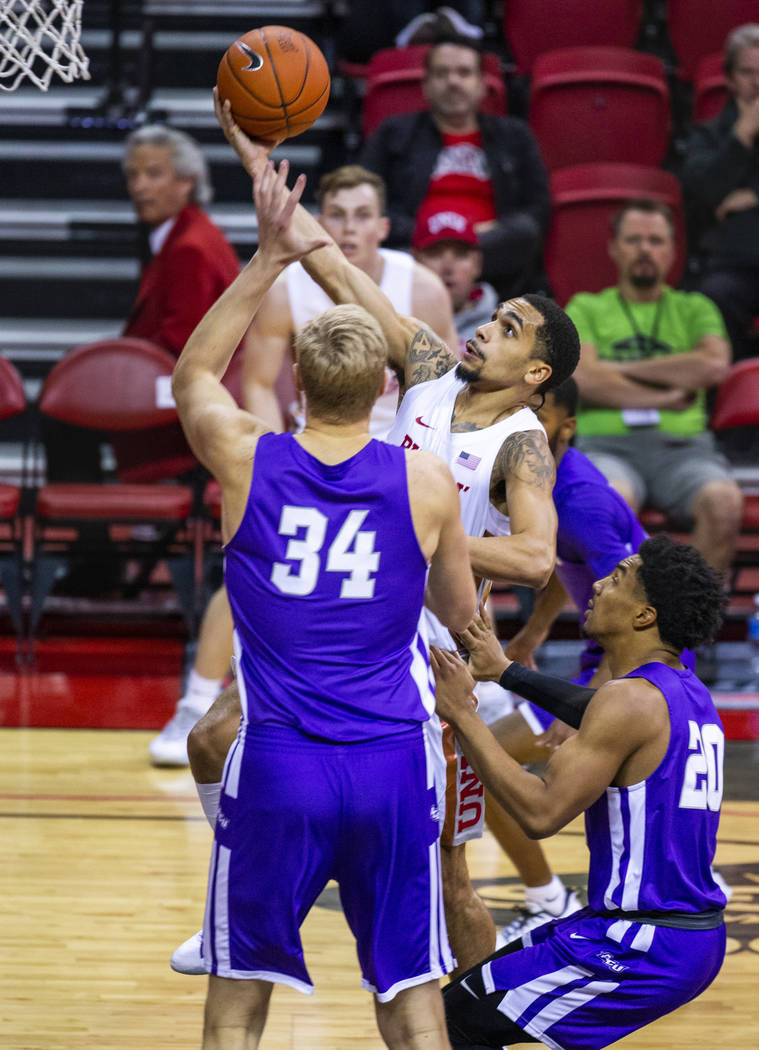 UNLV Rebels guard Elijah Mitrou-Long (55, center) elevates in the lane past Abilene Christian W ...