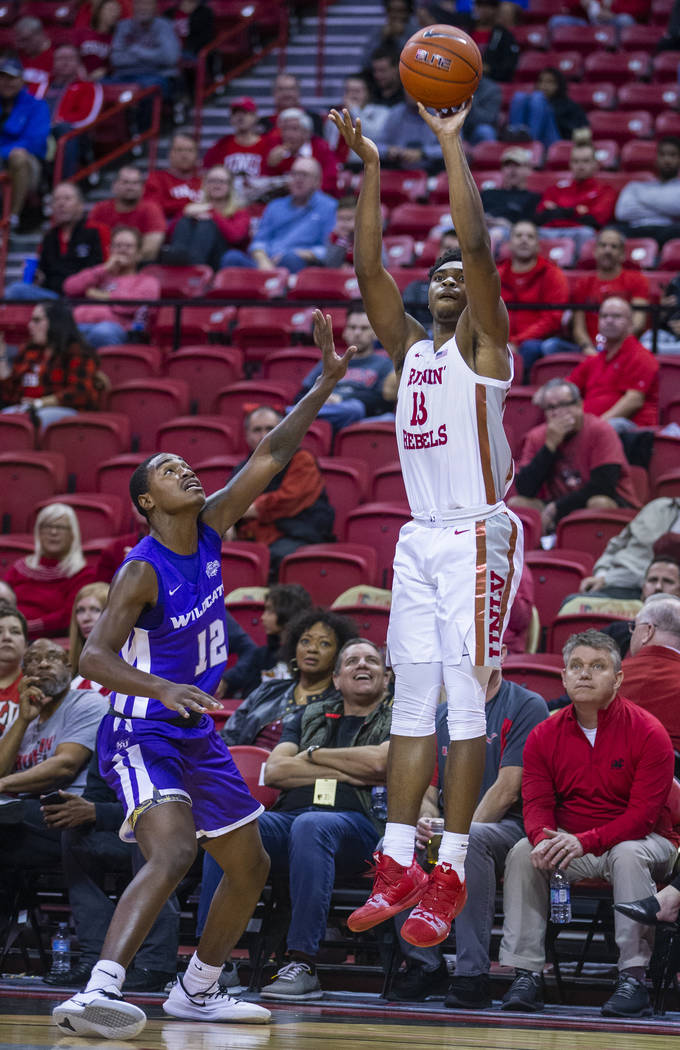 UNLV Rebels guard Bryce Hamilton (13, right) elevates for a three-point shot over Abilene Chris ...