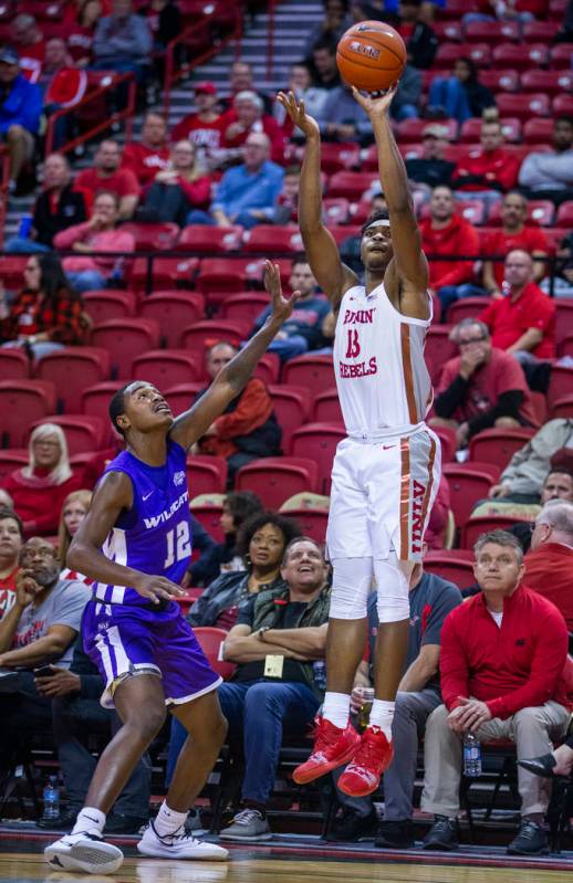 UNLV Rebels guard Bryce Hamilton (13, right) elevates for a three-point shot over Abilene Chris ...