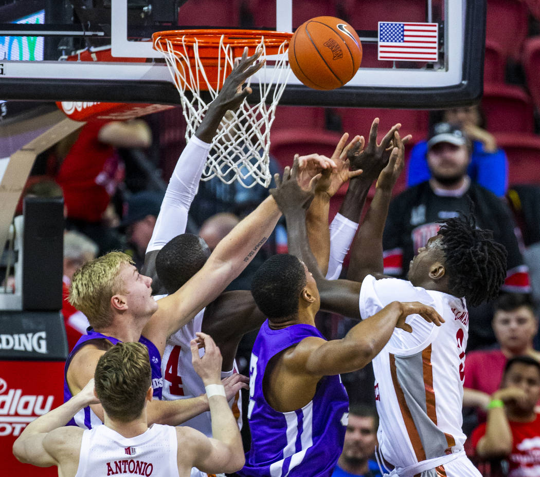 UNLV Rebels forward Donnie Tillman (2, right) battles for a rebound under the basket with Abile ...