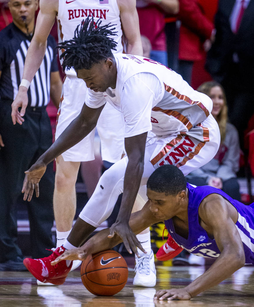 UNLV Rebels forward Donnie Tillman (2, above) battles for a loose ball on the court with Abilen ...