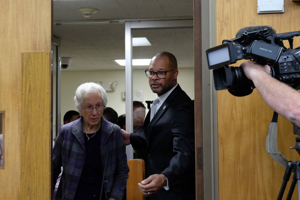 Nevada Attorney General Aaron Ford assists Cecily O'Connor, the mother of murder victim Julia W ...