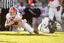 Indiana quarterback Peyton Ramsey (12) dives toward the end zone as he slips the grasp of Penn ...