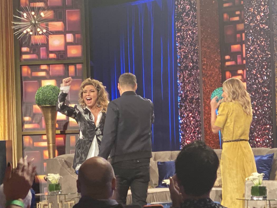 Shania Twain responds to a standing ovation as she is greeted by Ryan Seacrest and Kelly Ripa o ...