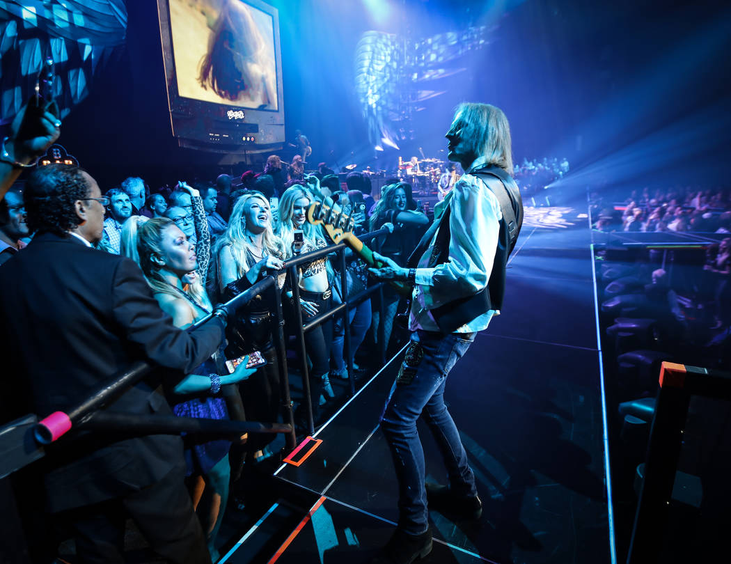 Tom Hamilton of Aerosmith is shown performing on the bar in the onstage VIP section at Park The ...