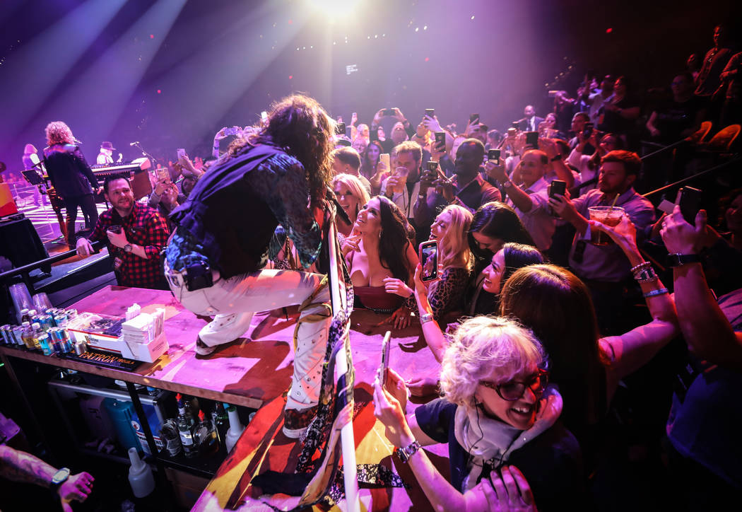 Steven Tyler of Aerosmith is shown performing on the bar in the onstage VIP section at Park The ...