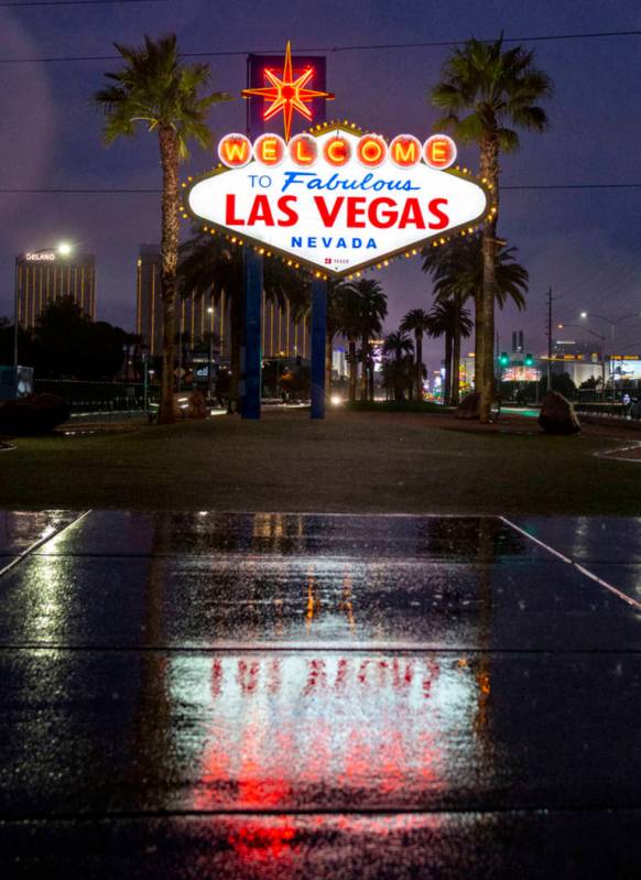 Rain falls at the Welcome to Fabulous Las Vegas sign at the Strip in Las Vegas on Wednesday mor ...