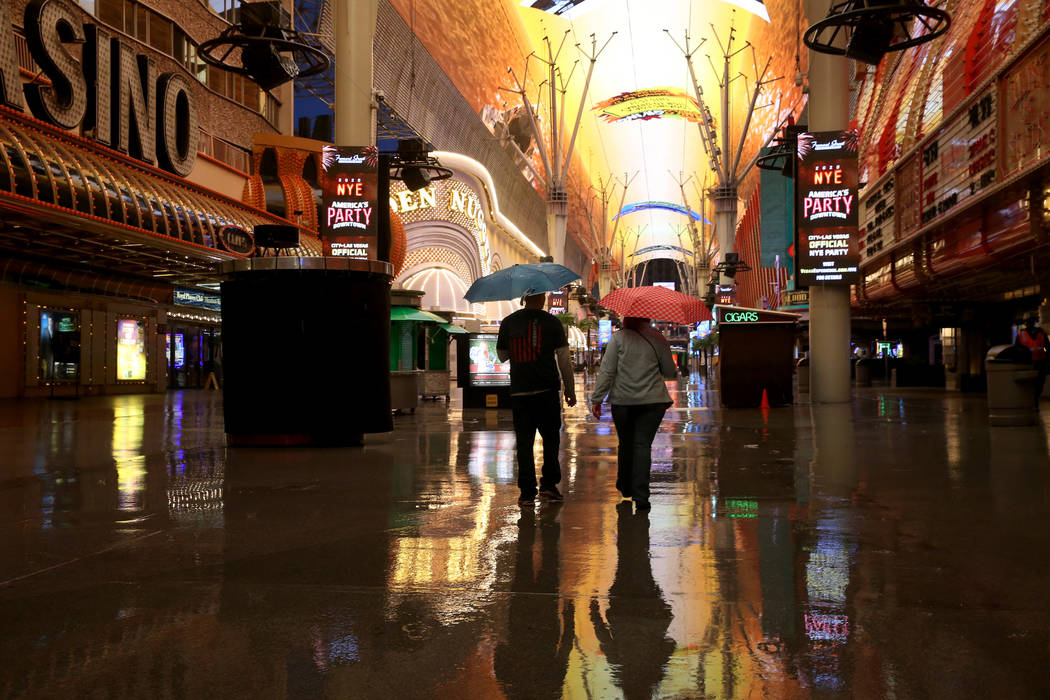 People walk through the Fremont Street Experience in downtown Las Vegas, Wednesday, Nov. 20, 20 ...