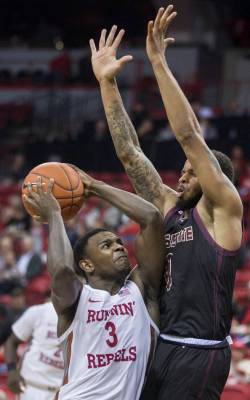 UNLV Rebels guard Amauri Hardy (3) leans in on Texas State Bobcats guard DeShawn Davidson (0) o ...