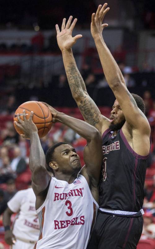 UNLV Rebels guard Amauri Hardy (3) leans in on Texas State Bobcats guard DeShawn Davidson (0) o ...