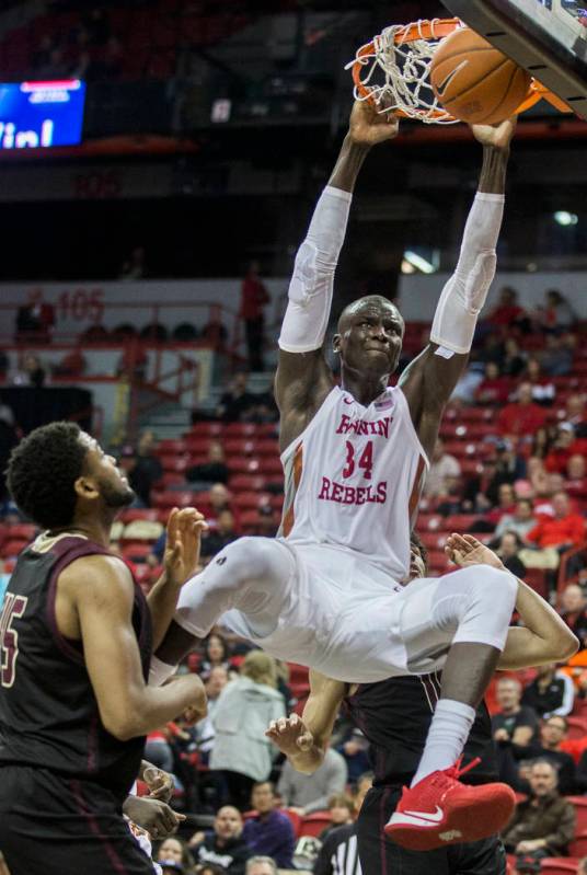 UNLV Rebels forward Cheikh Mbacke Diong (34) dunks over Texas State Bobcats forward Alonzo Sule ...