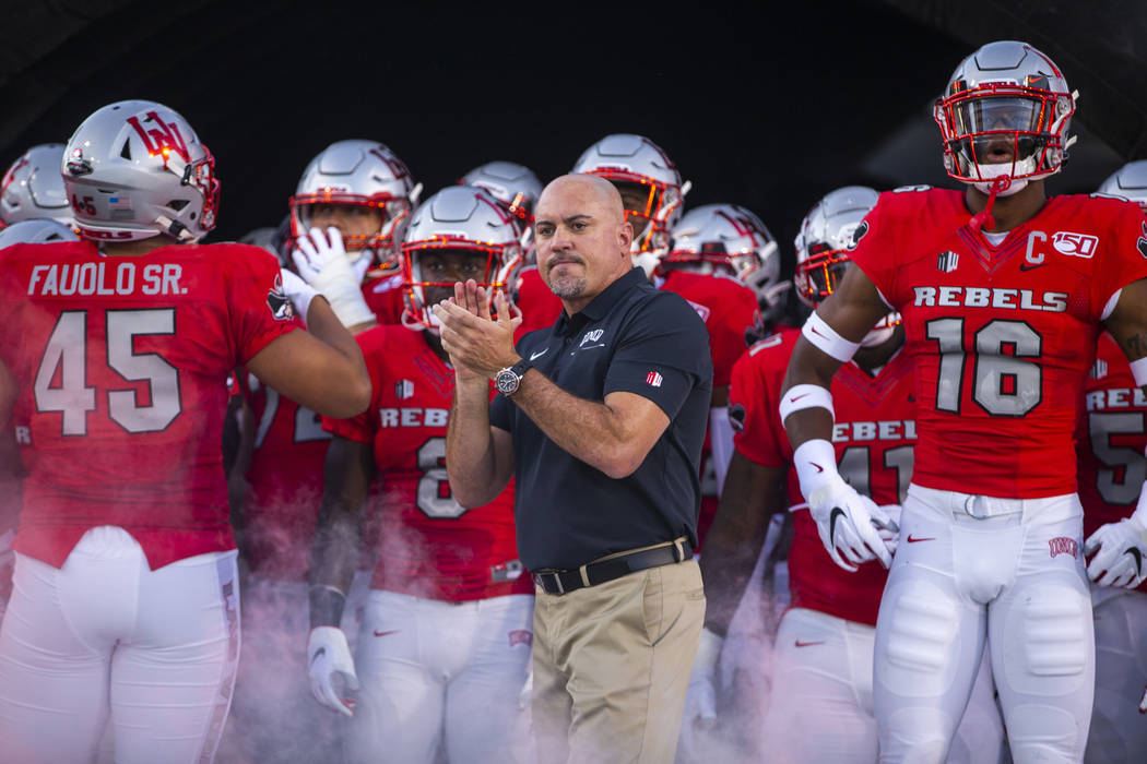 In this Aug. 31, 2019, file photo, UNLV Head Coach Tony Sanchez, center, waits with his team to ...
