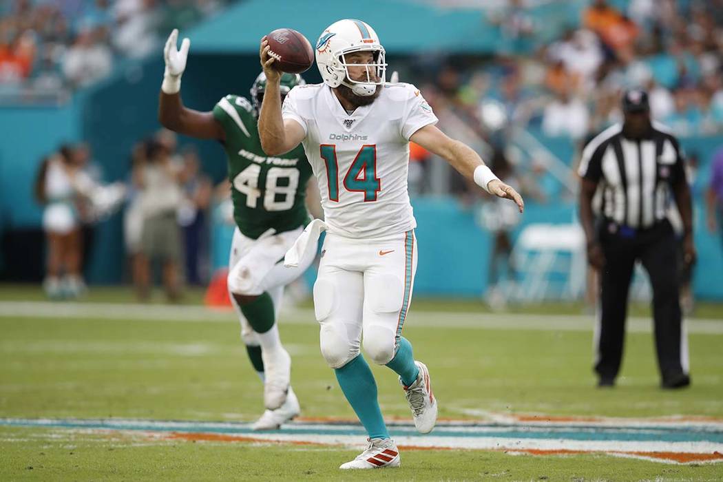 Miami Dolphins quarterback Ryan Fitzpatrick (14) throws a pass against the New York Jets during ...