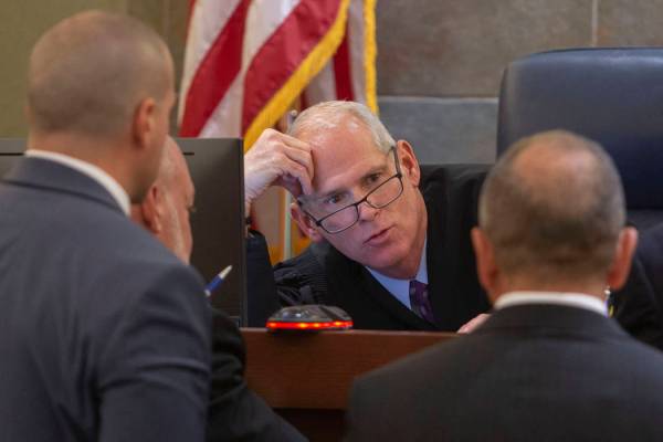 Judge Douglas Herndon, center, speaks to state prosecutors and defense attorneys during a trial ...