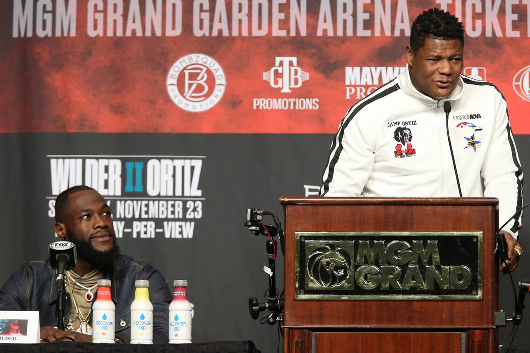 Luis Ortiz, right, speaks during a press conference with his upcoming boxing opponent Deontay W ...
