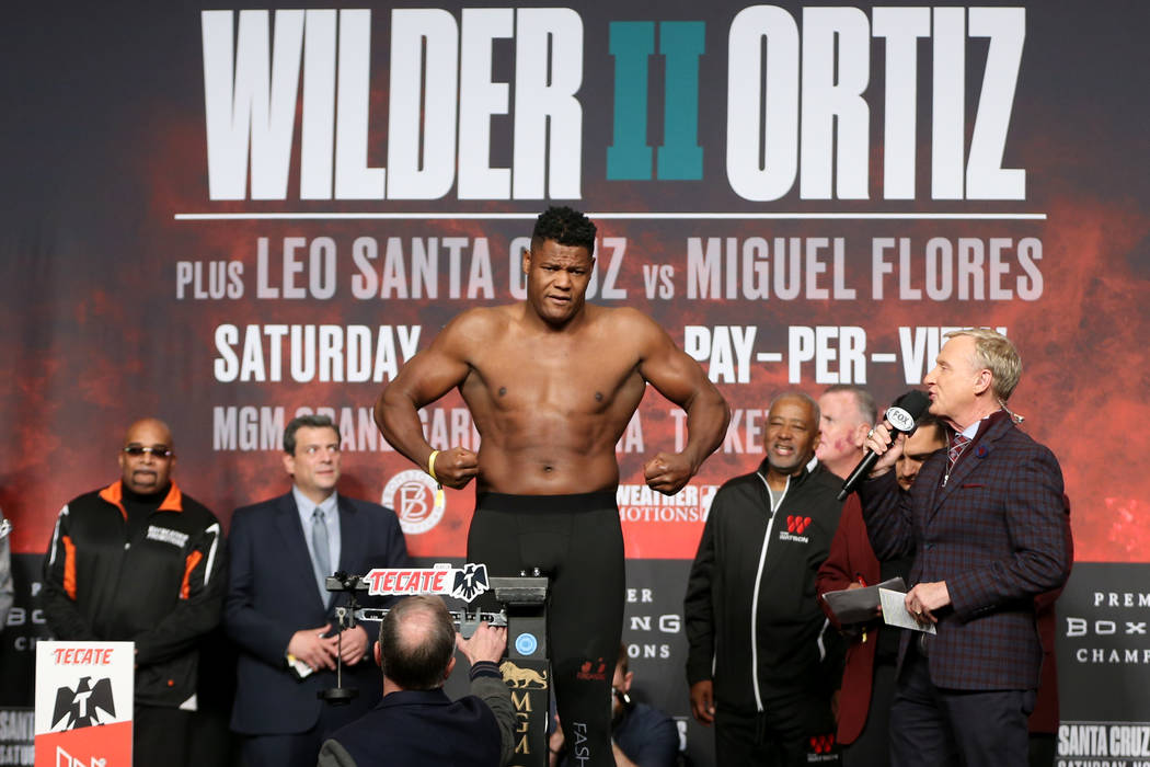 Luis Ortiz stands on the scale during a weigh-in at the MGM Grand Garden Arena in Las Vegas, Fr ...