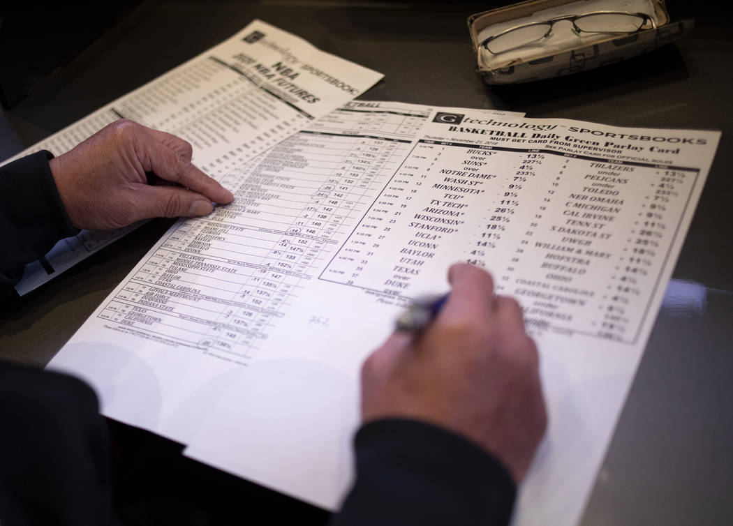 A gambler places a bet at the Palms sportsbook on Thursday, Nov. 21, 2019, in Las Vegas. (Ellen ...