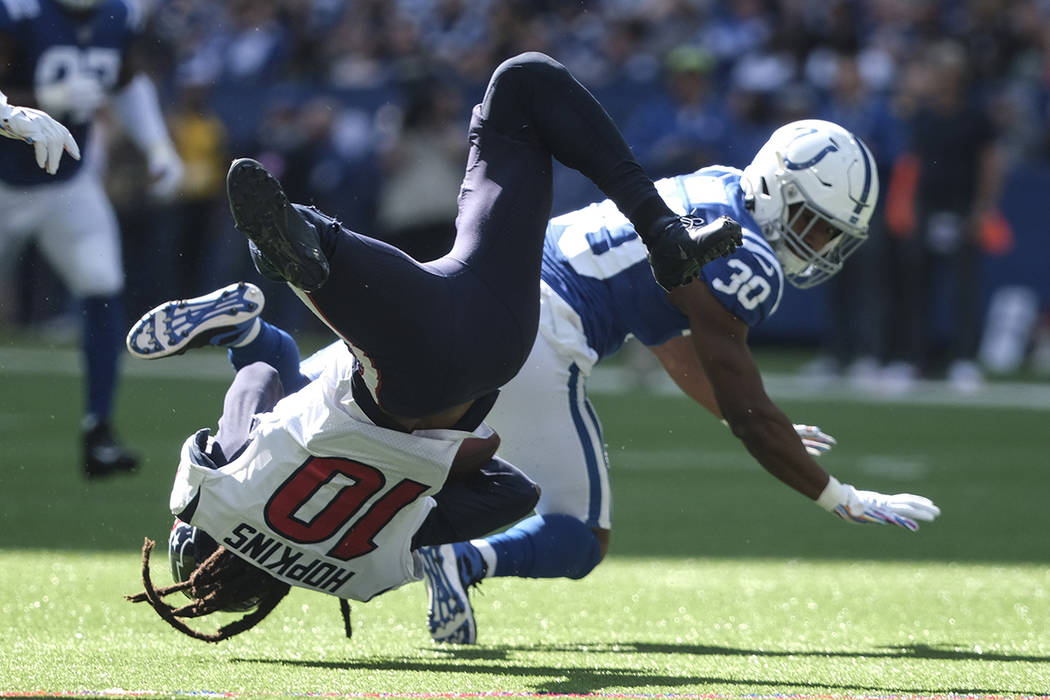 Houston Texans wide receiver DeAndre Hopkins (10) makes a catch while being tackled by Indianap ...