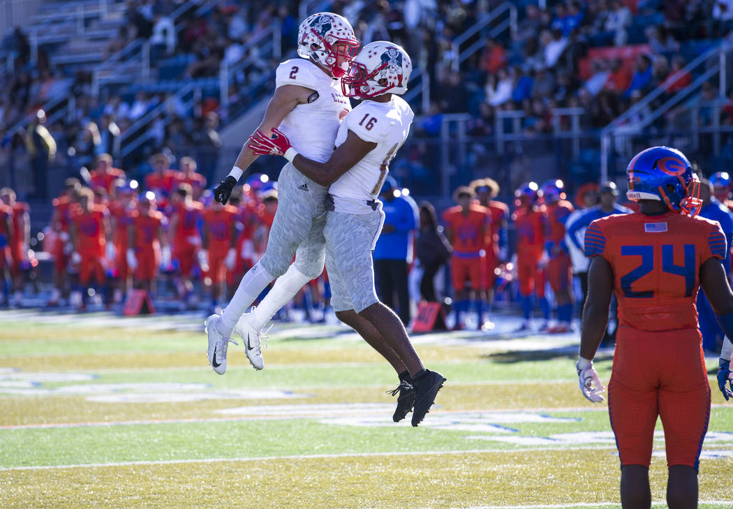 Liberty wide receiver Maurice Hampton (16) celebrates with David Elder (2) after scoring a touc ...