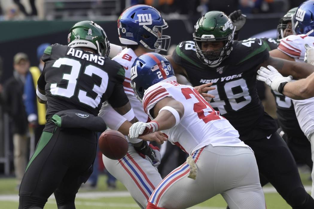 New York Jets strong safety Jamal Adams (33) knocks the ball away from New York Giants quarterb ...