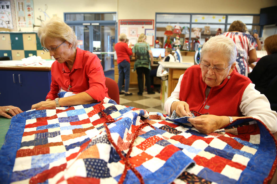 Pam Blatzheim, left, and Gloria Mortenson, work on a quilt during a meet by the Quilters for Ve ...