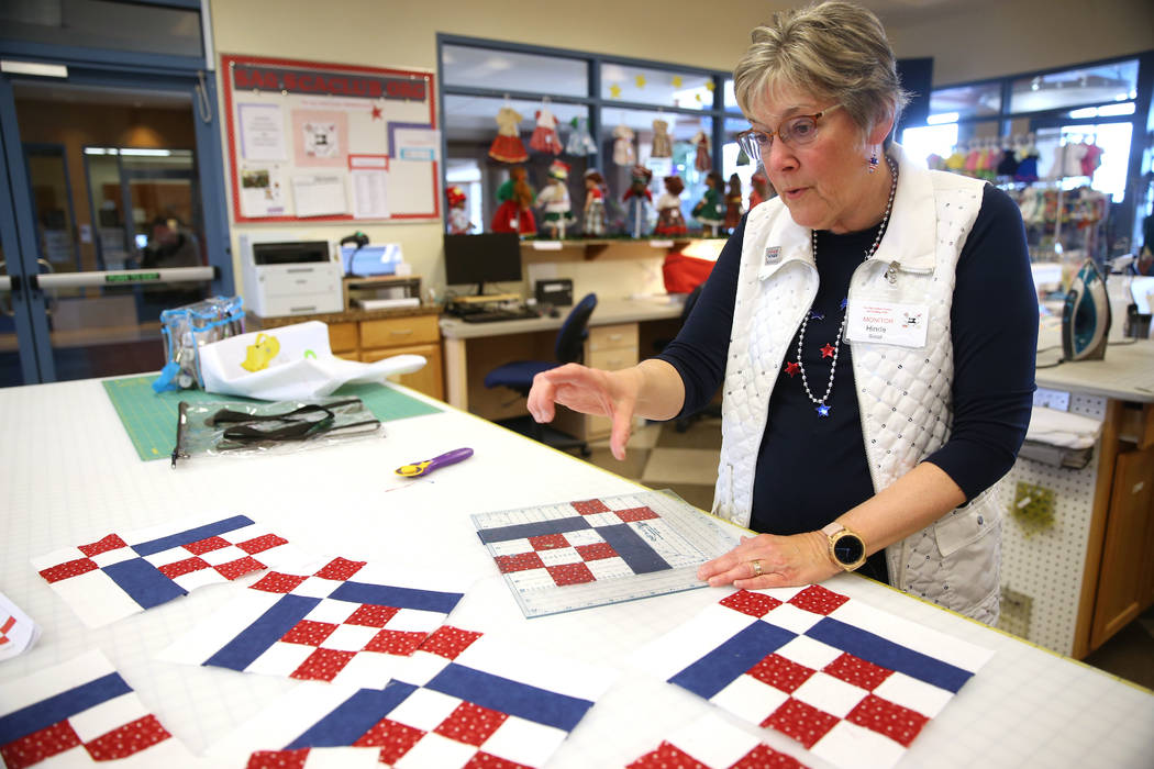 Hinde Socol works on a pattern for a quilt during a meet by the Quilters for Veterans to make p ...