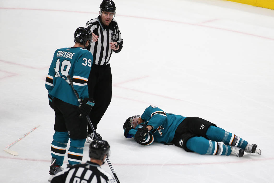 Sharks center Joe Pavelski (8) lays on the ice after getting hit by Knights center Cody Eakin ( ...