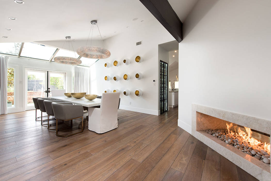 The formal dining room features a modern-design fireplace and opens to the patio. (Simply Vegas)