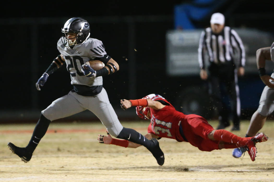 Bishop Gorman Jaydn Ott (20) runs the ball against Liberty's Ikalewa Paaoao (31), in the second ...