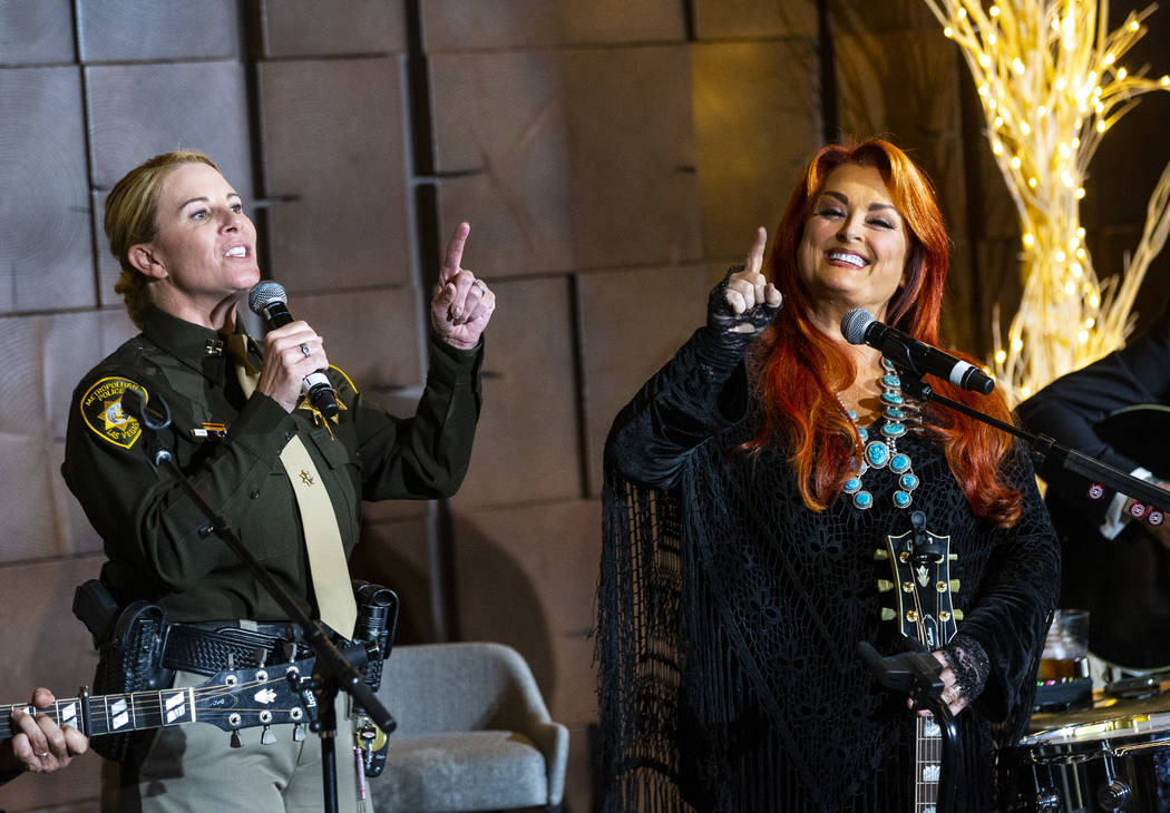 Metropolitan Police Department Captain Kelly McMahill, left, performs with singer-songwriter Wy ...