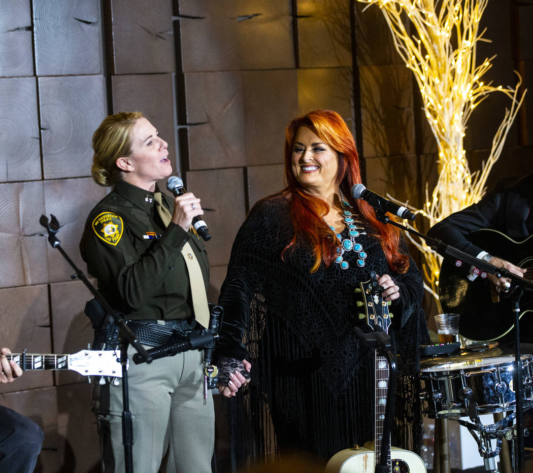 Metropolitan Police Department Captain Kelly McMahill, left, performs with singer-songwriter Wy ...