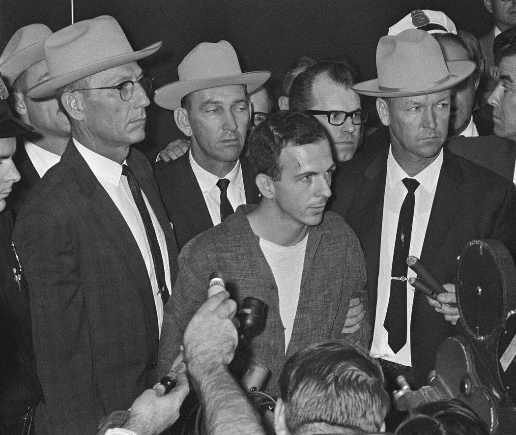 Lee Harvey Oswald is shown early Nov. 23, 1963, as he stood before newsmen in a Dallas police s ...