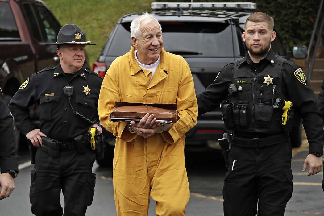 Former Penn State University assistant football coach Jerry Sandusky, center, arrives at the Ce ...