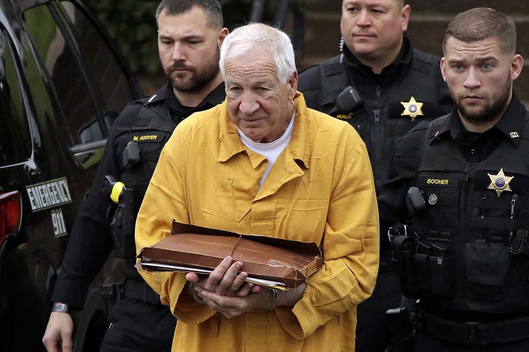 Former Penn State University assistant football coach Jerry Sandusky, center, arrives at the Ce ...