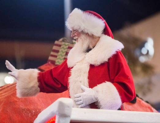 Santa waves to the crowd during the Downtown Summerlin Holiday Parade on Festival Plaza Drive o ...