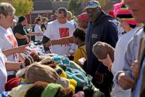 Crowds of people pick out hats and toiletry items at Project Homeless Connect at the Champion C ...