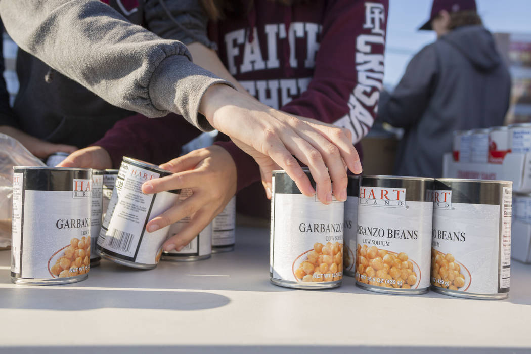 Faith Lutheran Middle School students set up their food stations to be given out while voluntee ...